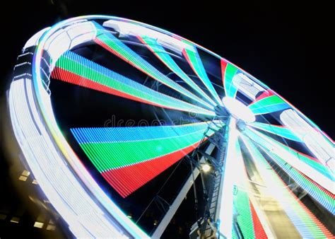 Long Exposure Motion Blur Of A Spinning Ferris Wheel At Night