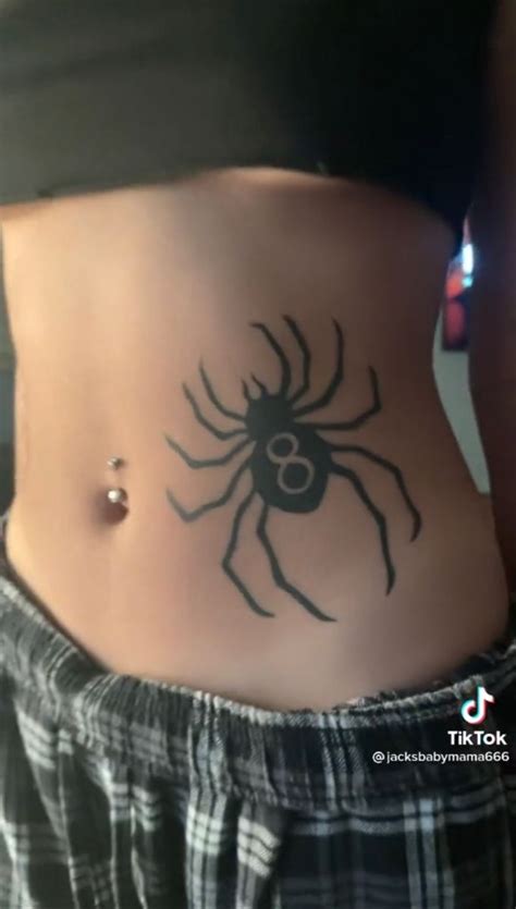 A Woman S Stomach With A Spider Tattoo On Her Belly And The Bottom Part Of Her Abdomen