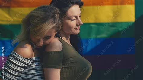 Young Lesbian Lgbt Couple On A Background Of The Rainbow Flag Lgbt