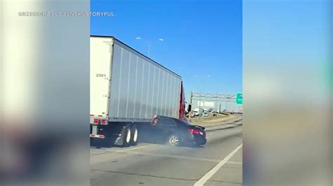 caught on video car pinned under semi truck dragged along chicago area freeway abc7 los angeles