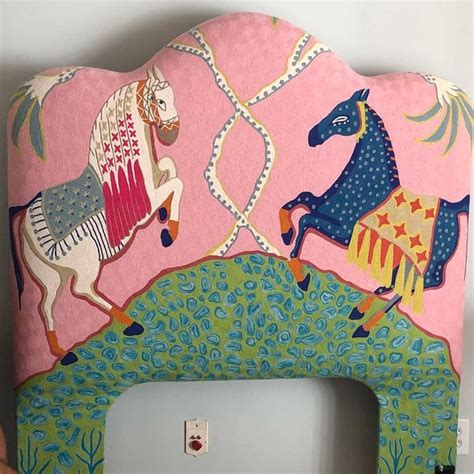 A Pink Headboard With Horses Painted On It