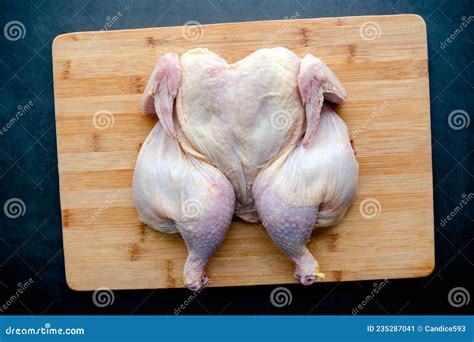 Raw Spatchcocked Chicken On A Bamboo Cutting Board Stock Image Image Of Bamboo Gray 235287041