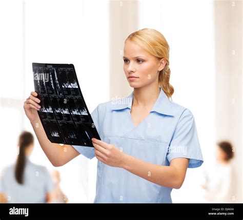 Serious Doctor Or Nurse Looking At X Ray Stock Photo Alamy