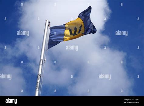 The Flag Of Barbados A Black Broken Trident On A Triband Of Two Bands Of Ultramarine Blue And