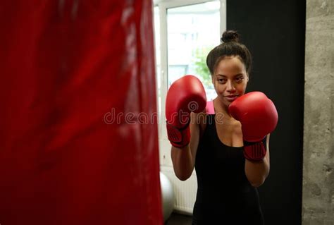 Beautiful African Female Athlete Boxer Wearing Red Boxing Gloves