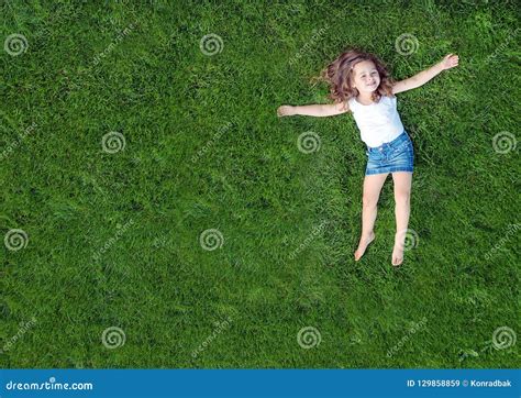 Relaxed Little Girl Lying On A Fresh Green Lawn Stock Image Image Of