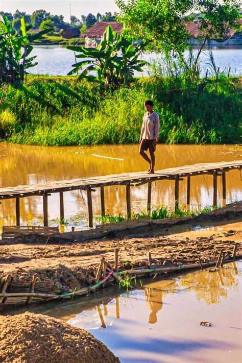Myanmar Rural Farmer Person Walking Over Bamboo River Bridge Editorial