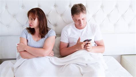 Relationship Problems Concept A Middle Aged Couple Lying In Bed In