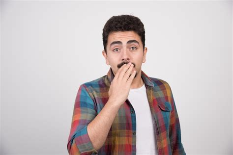 Free Photo Shocked Man Holding His Hand To His Mouth