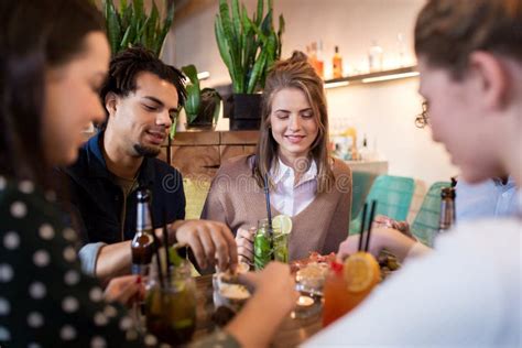 Happy Friends Eating And Drinking At Bar Or Cafe Stock Image Image Of