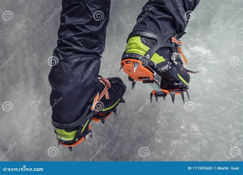 Climber On A Frozen Waterfall Crampons Close Up On His Feet Ice