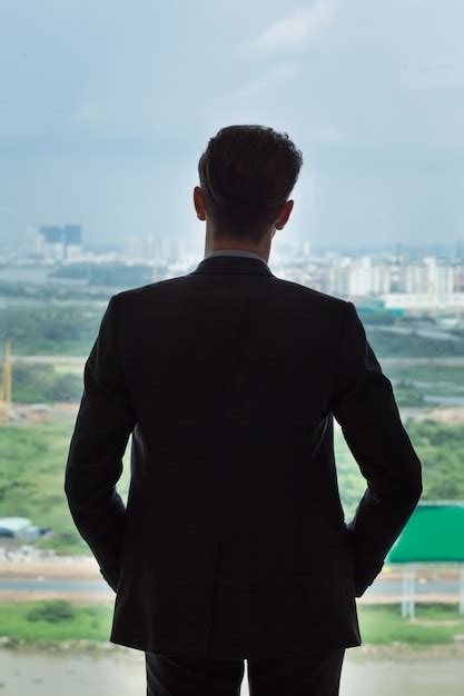 Free Photo Back View Of Businessman Standing By Window