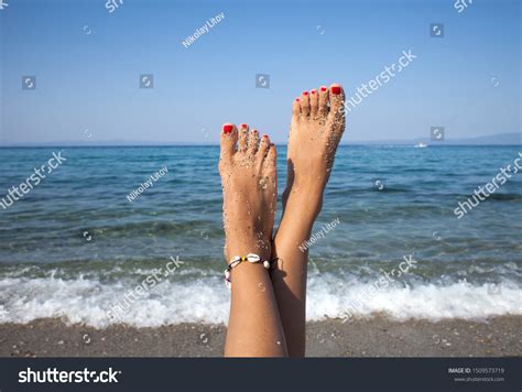 Woman Tanned Legs On Sand Beach Stock Photo Edit Now