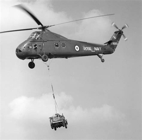 helicopter demonstration flight by the fleet air arm carrying a land rover navy aircraft ww2