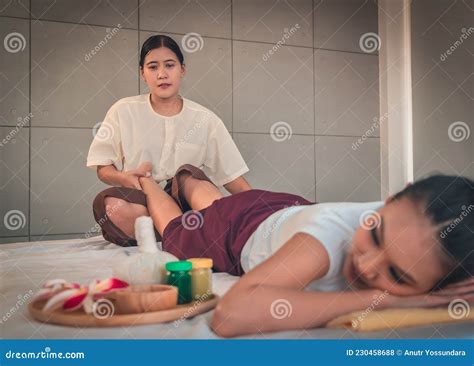 Female Asian Getting Leg Massage By Thai Masseur In Asian Style Massage
