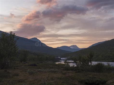 Wild River With Birch Tree Forest And Mountains In Sunset Light