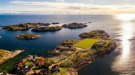 Henningsvær is a fishing village located on several small islands off the southern coast of austvågøya in the lofoten archipelago in norway. Aerial view of Henningsvær village with its football field ...