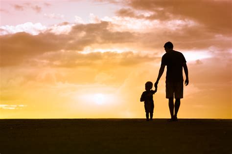 Father And Son Walking At Sunset Stock Photo Download Image Now