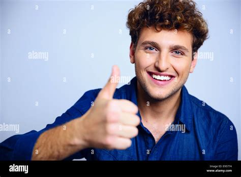 Happy Man Giving Thumbs Up Sign On Blue Background Stock Photo Alamy