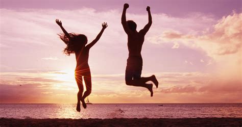 Excited Happy Cheering People Jumping On Beach At Sunset Summer Travel
