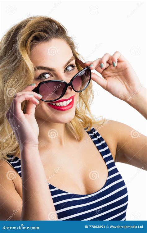Portrait Of Beautiful Woman Posing With Sunglasses Against White