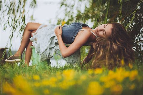 Girl Laying On A Bench And Relaxing Outdoors By Stocksy Contributor
