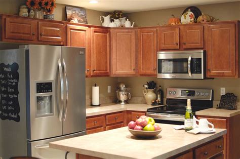 Use your kitchen cabinet tops as a space to stash things. Decorating the Top of Your Cabinets! | aschoenikeinteriors