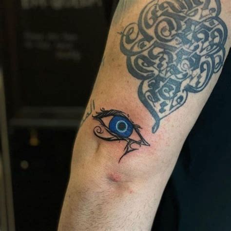 A Mans Arm With An Evil Eye Tattoo On It