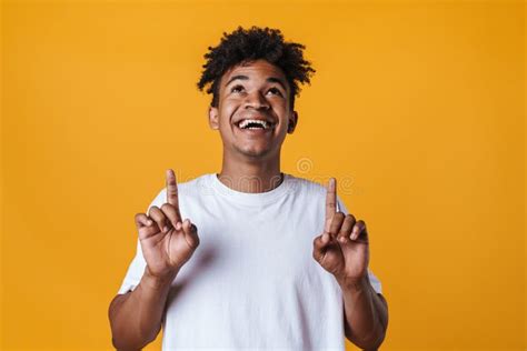 Image Of Happy African American Guy Smiling And Pointing Fingers Upward