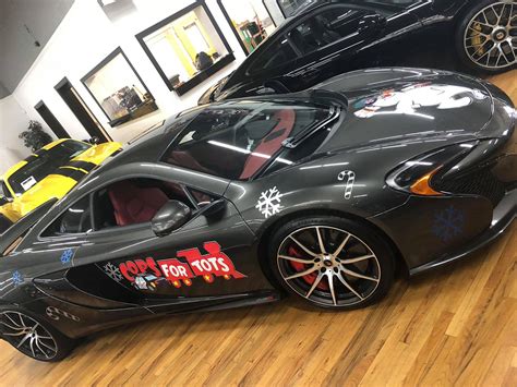 Cosmo Motors - The McLaren and Ferrari are decaled and...