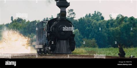 Michael Fassbender As Burke Lower Right Watches As A Train Begins To Explode In Warner Bros