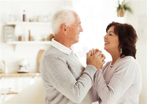 Happy Active Elderly Senior Couple Dancing In Kitchen Lifestyle And Old People Concept Stock