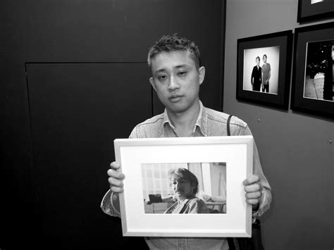 Chikashi Suzuki holding his portrait of Fumihiro Hayashi (Charlie Brown ...