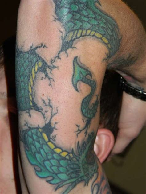 Forearm wrap tattoo another set of classic roses wraps around the forearm ty. more of dragon wrap around tattoo