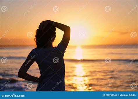 Silhouette Of A Woman At Sunrise The Girl Looks At The Sea And The