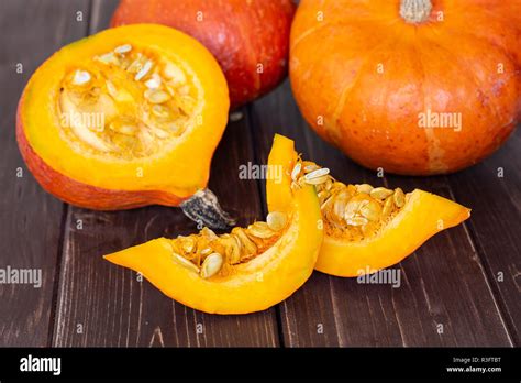 Group Of Two Whole One Half Two Slices Of Fresh Red Kuri Pumpkin