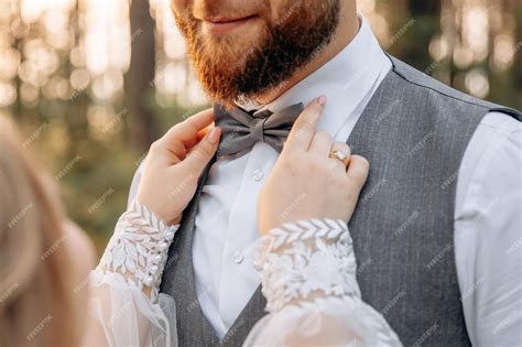 Premium Photo A Woman Compares A Bow Tie To Her Husband With A Beard