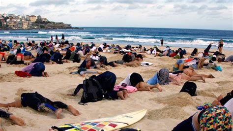 Australians Bury Heads In Sand To Mock Governments Stance On Climate