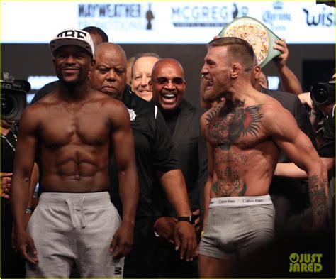 conor mcgregor and floyd mayweather face off at the weigh ins ahead of big fight photo 3945651