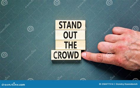 Stand Out the Crowd Symbol. Concept Words Stand Out the Crowd on Wooden