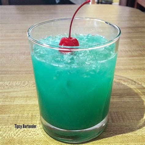 A Blue Drink With A Cherry On The Rim