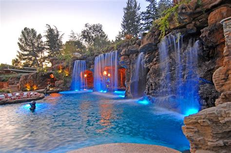 Grotto Swimming Pool With Lights On Follow Us On