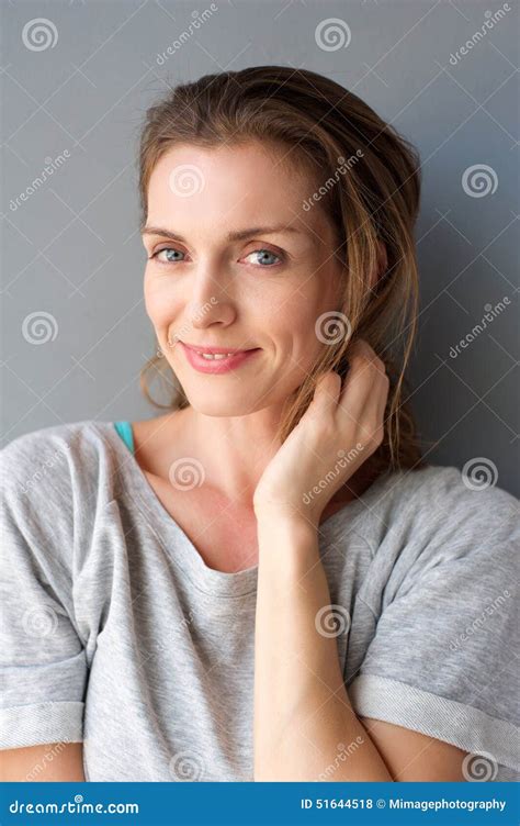 Lovely Mid Adult Woman Smiling With Hand In Hair Stock Photo Image Of