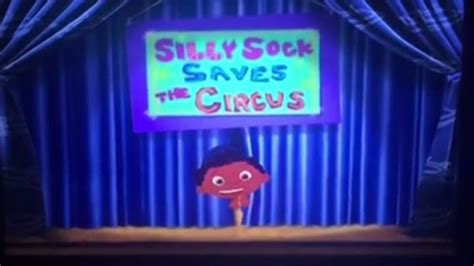 Silly Sock Saves The Circus On Stage With Blue Curtain And Neon Sign In