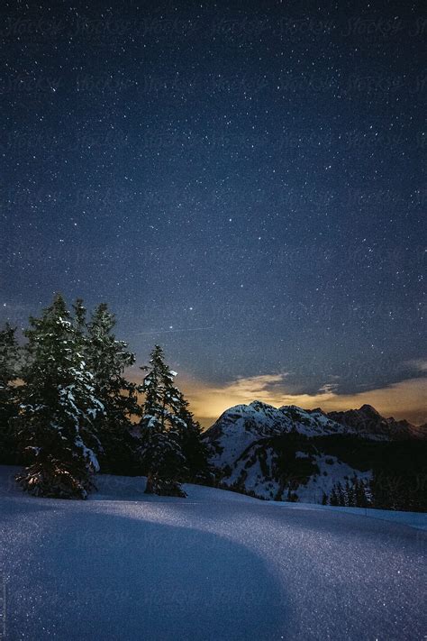 Snowcovered Austrian Mountain Landscape Under Starry Night By Stocksy