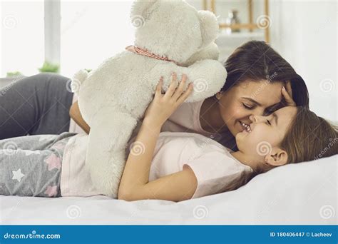 Happy Mother`s Day Mother And Daughter Are Hugging While Lying On A
