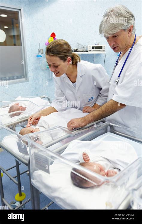 Pediatrician And Nurse With Newborn Babies Child Care Unit Stock Photo