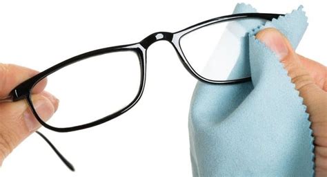 Close Up Of Person S Hand Cleaning Eyeglasses With Cloth Eyeglass Cleaner Eyeglass Cleaning