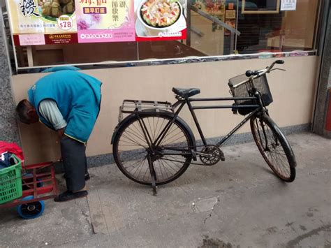 All things to do in hong kong. Classic bicycle and its owner on a Hong Kong street