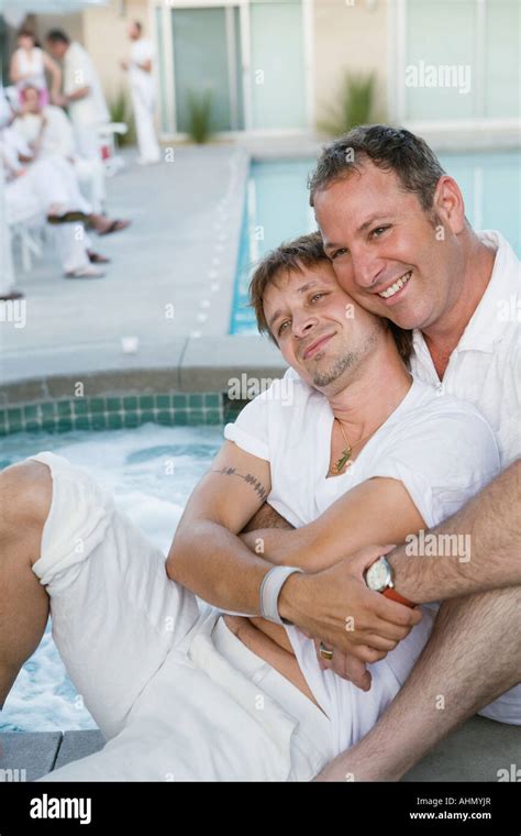 Gay Couple Hugging By Swimming Pool Stock Photo Alamy